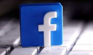 FILE PHOTO: A 3D-printed Facebook logo is seen placed on a keyboard in this illustration